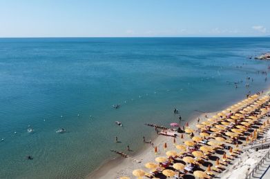 a beach with umbrellas and people on it