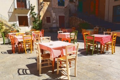 tables and chairs outside a building