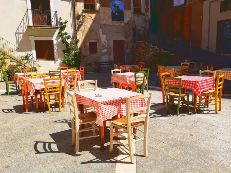 tables and chairs outside a building